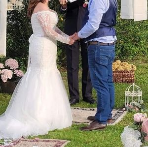 Wedding dress size 12 but fits like a 10. Mermaid style in ivory. Has a bustle